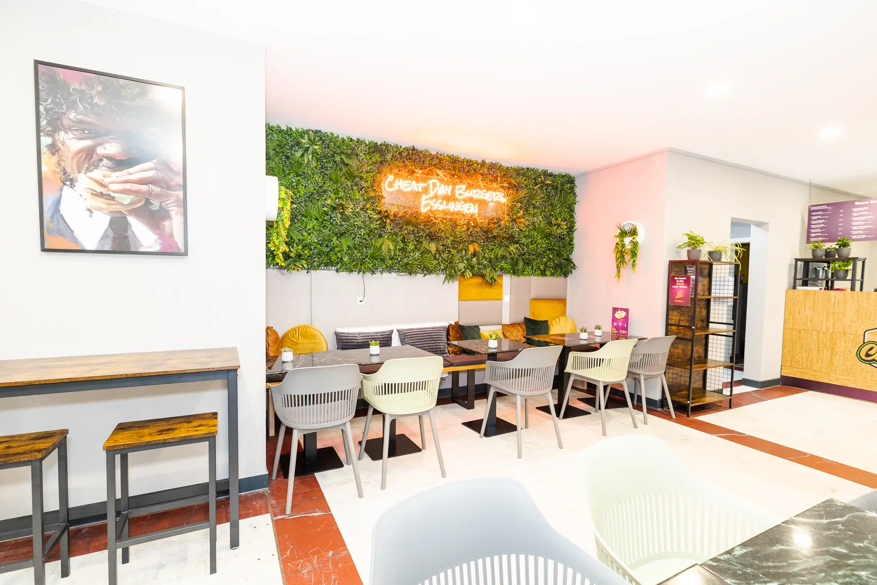 Gastraum mit Pflanzenwand und Neon-Schriftzug, Cheat Day Burgers, Esslingen — Innenaufnahme